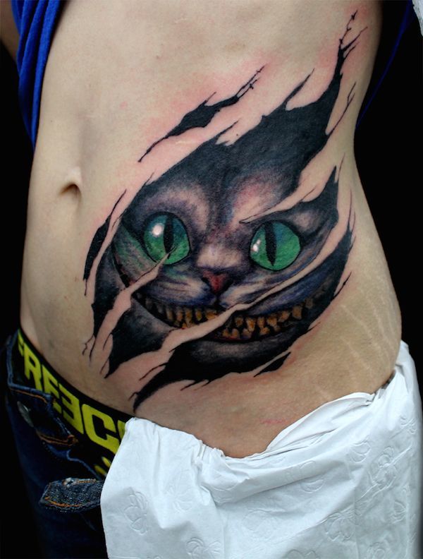 Ripped-Skin-Cheshire-Cat-Tattoo-On-Side-Rib.jpg