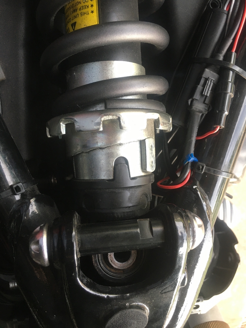 With back wheel supported and frame sitting on blocks, unscrew the bolts at each end.